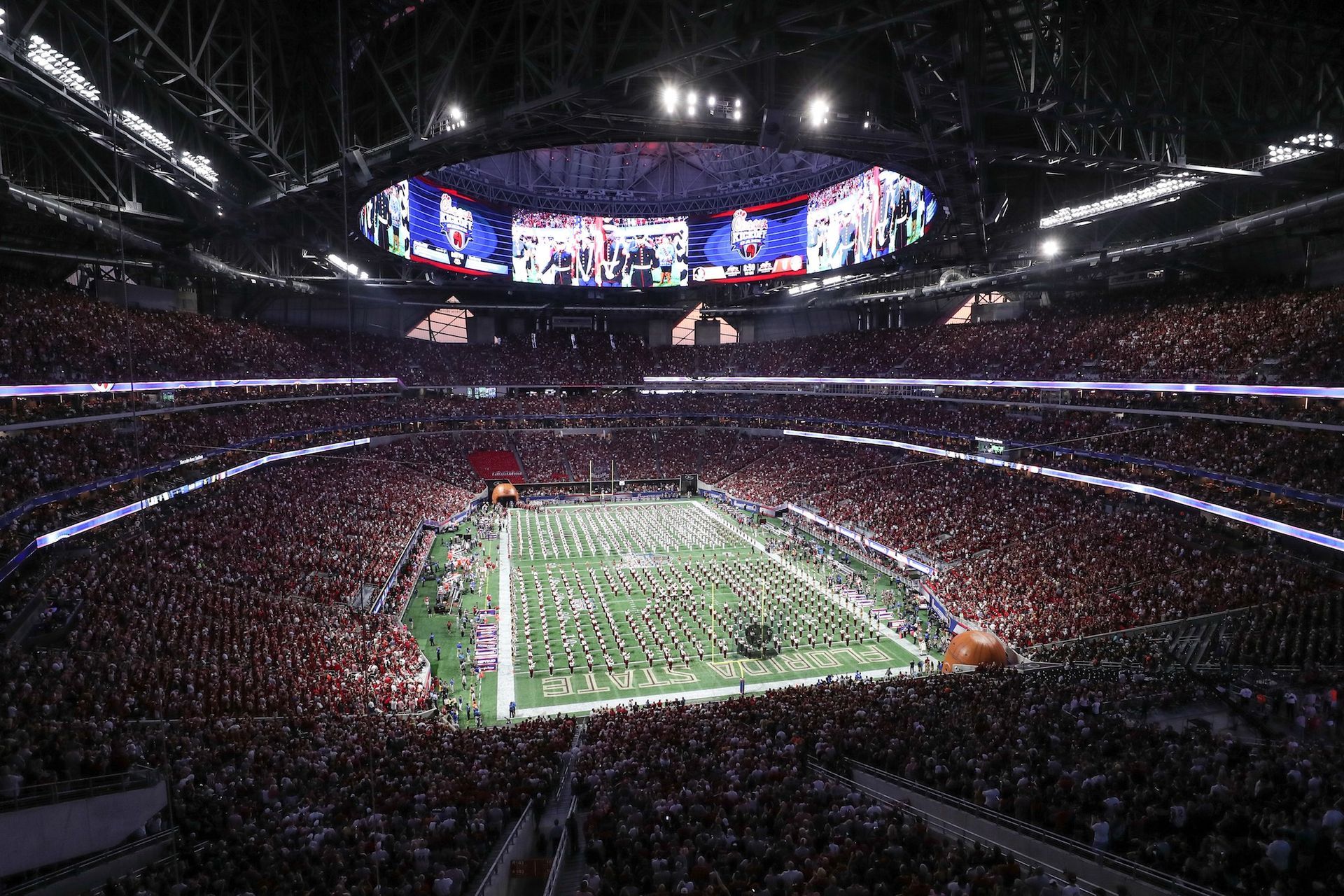 A large stadium filled with people watching a football game. EVENTS.LIMO