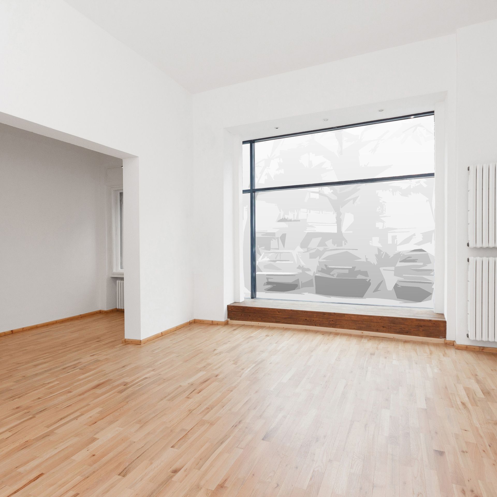An empty room with hardwood floors and a large window