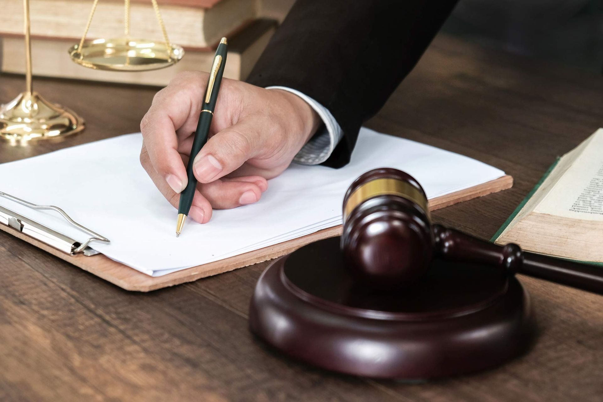 Close up of lawyer working on documents for child support case preparation in legal office.