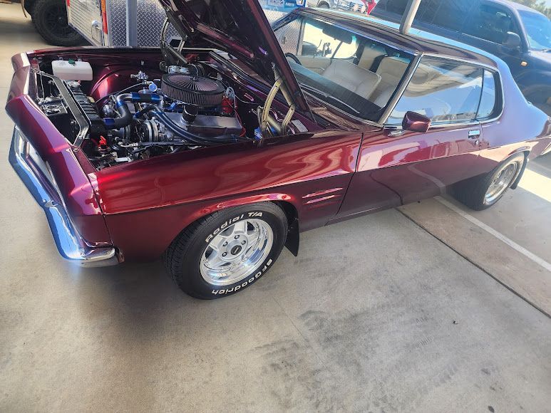 A Purple Car With the Hood Up is Parked in a Parking Lot — Roadworthy's On The Run in Crow's Nest, QLD