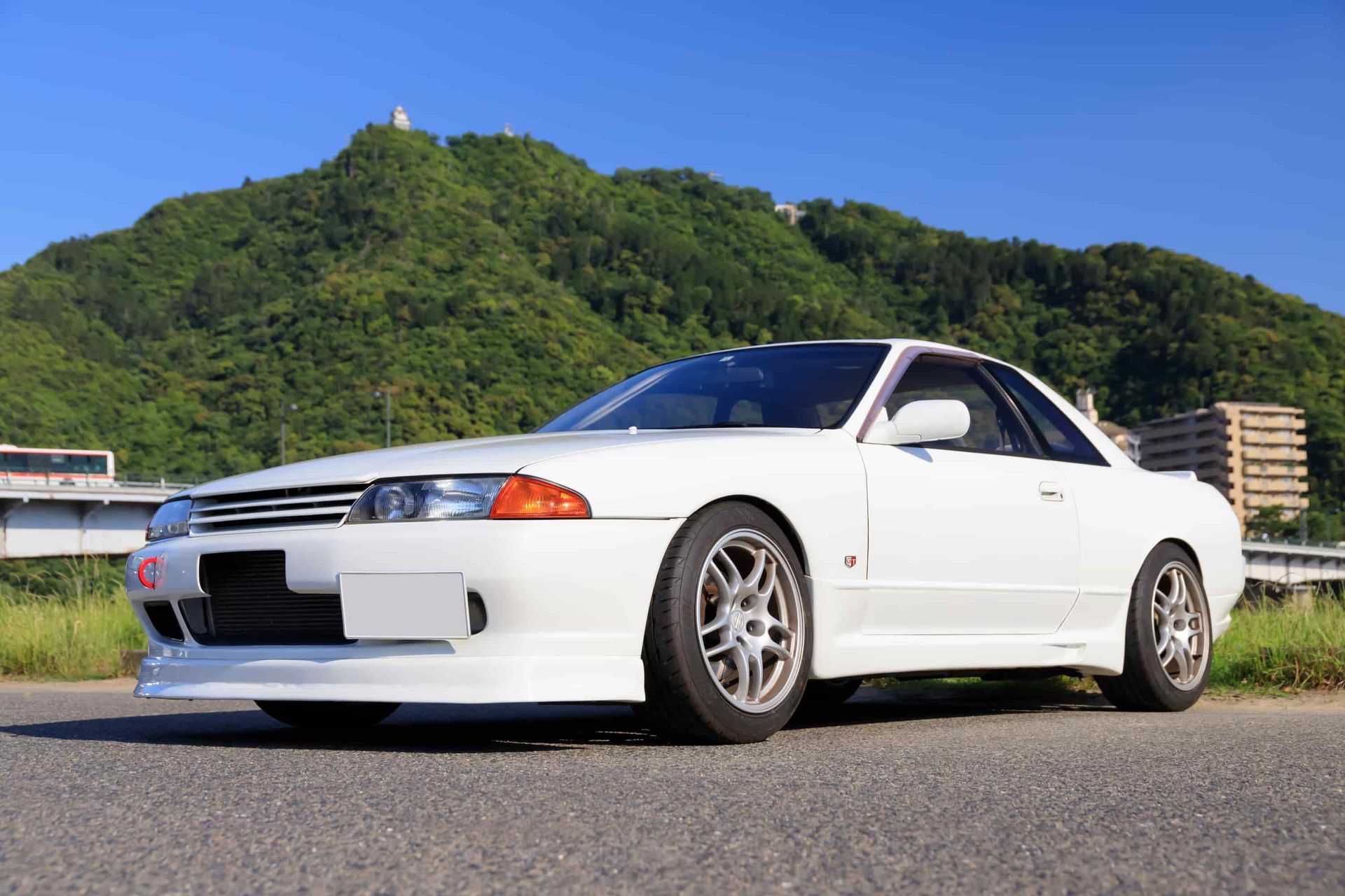 A White Sports Car is Parked on the Side of the Road in Front of a Mountain — Roadworthy's On The Run in Harristown, QLD