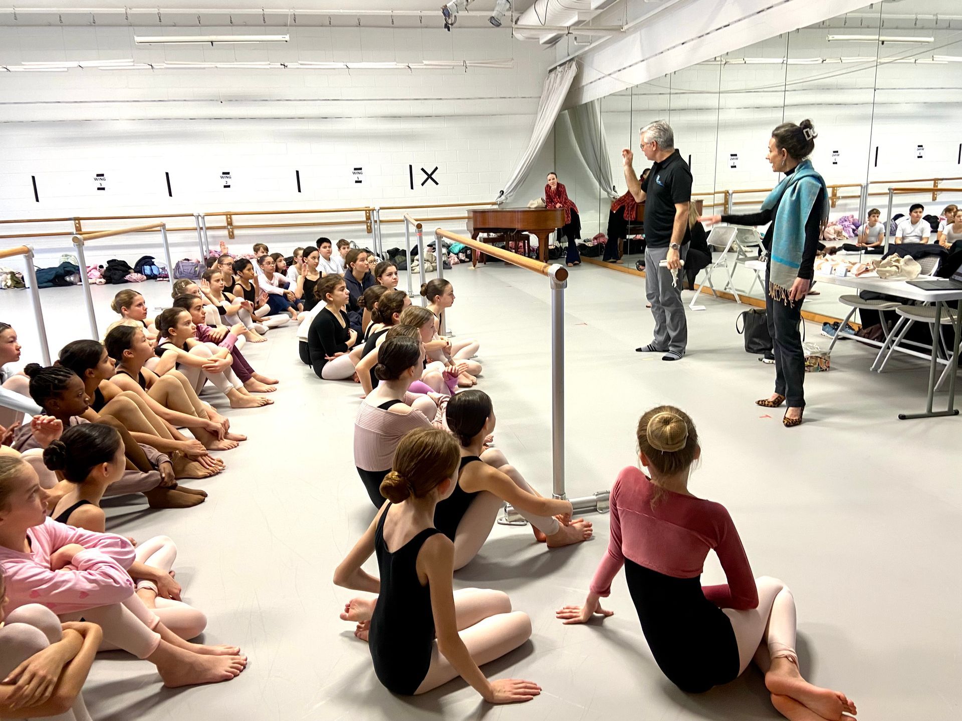 group of ballerinas at the ready, set, pointe class