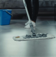 A person is mopping the floor with a mop.