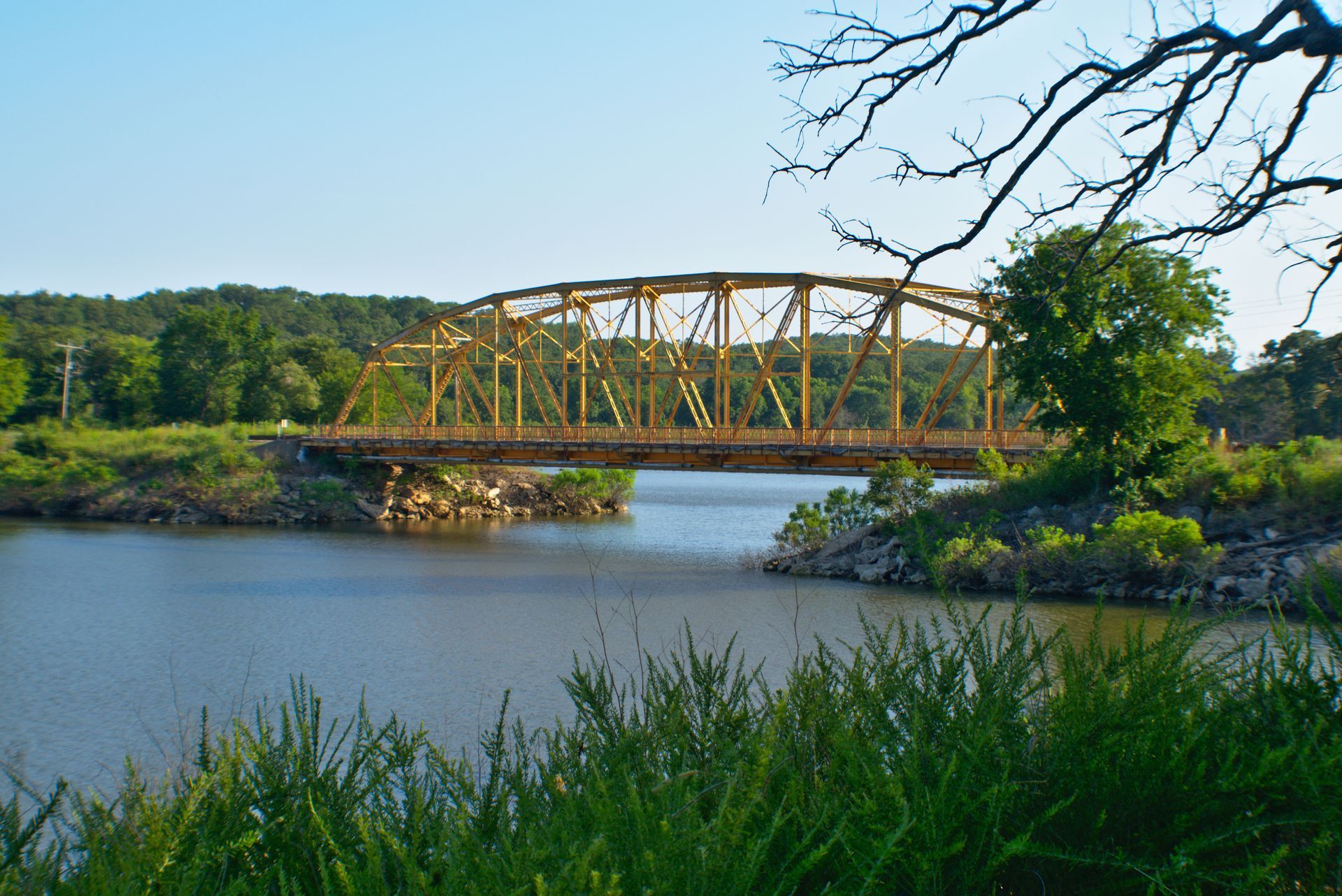 A bridge over a body of water with trees in the background