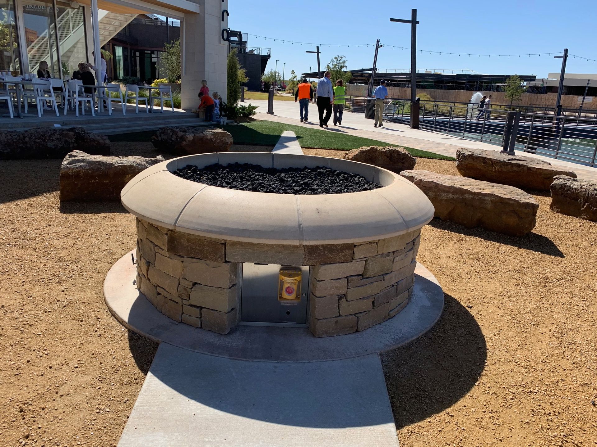 Gas fireplace with faux logs burning with blue and yellow flames, black firebox.
