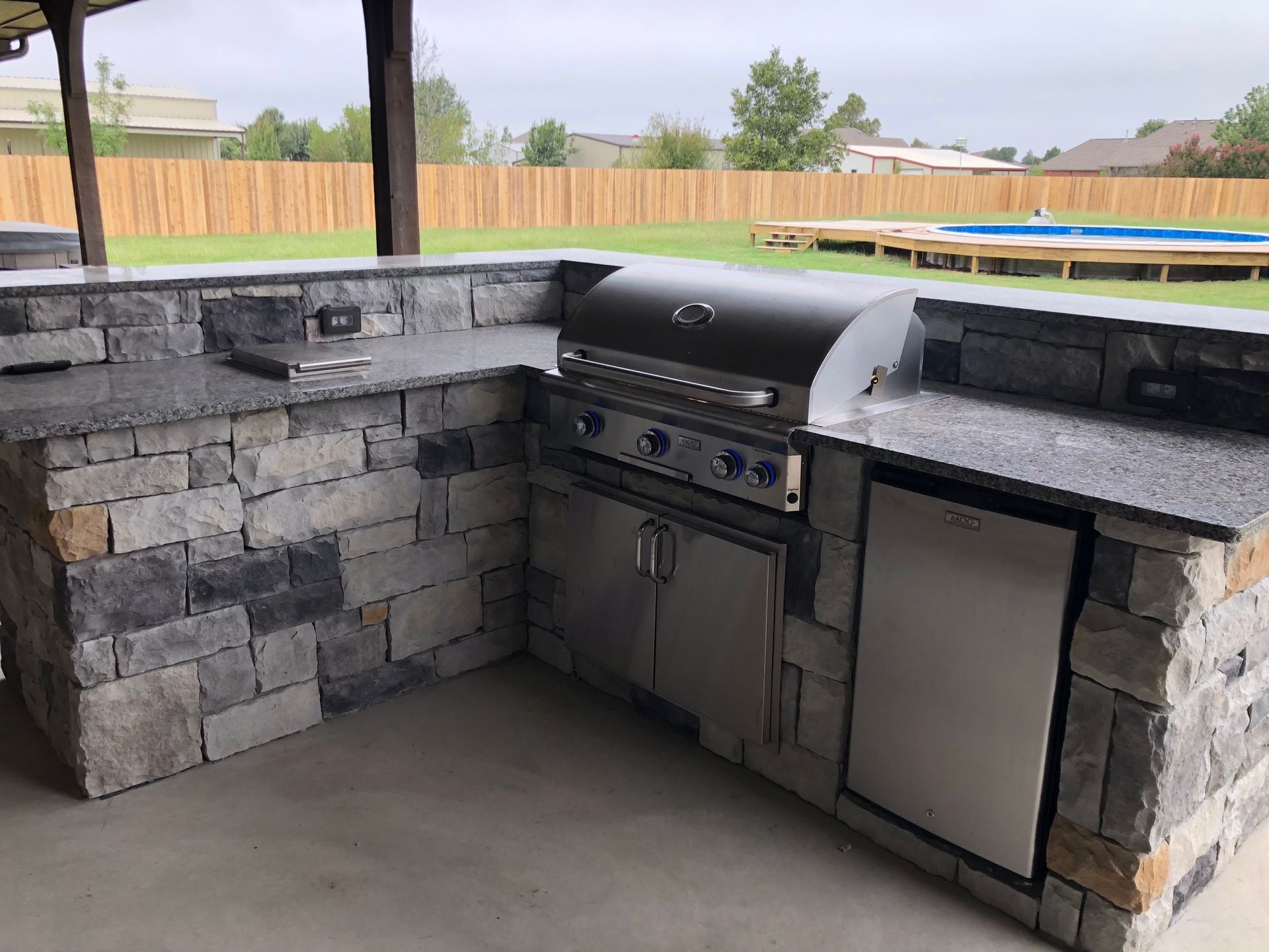 Gas fireplace with faux logs burning with blue and yellow flames, black firebox.