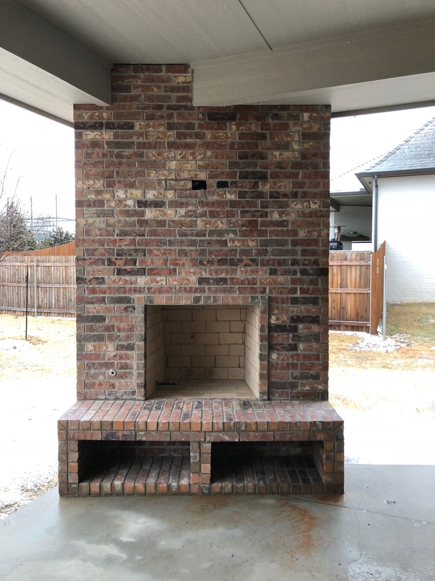 Gas fireplace with faux logs burning with blue and yellow flames, black firebox.