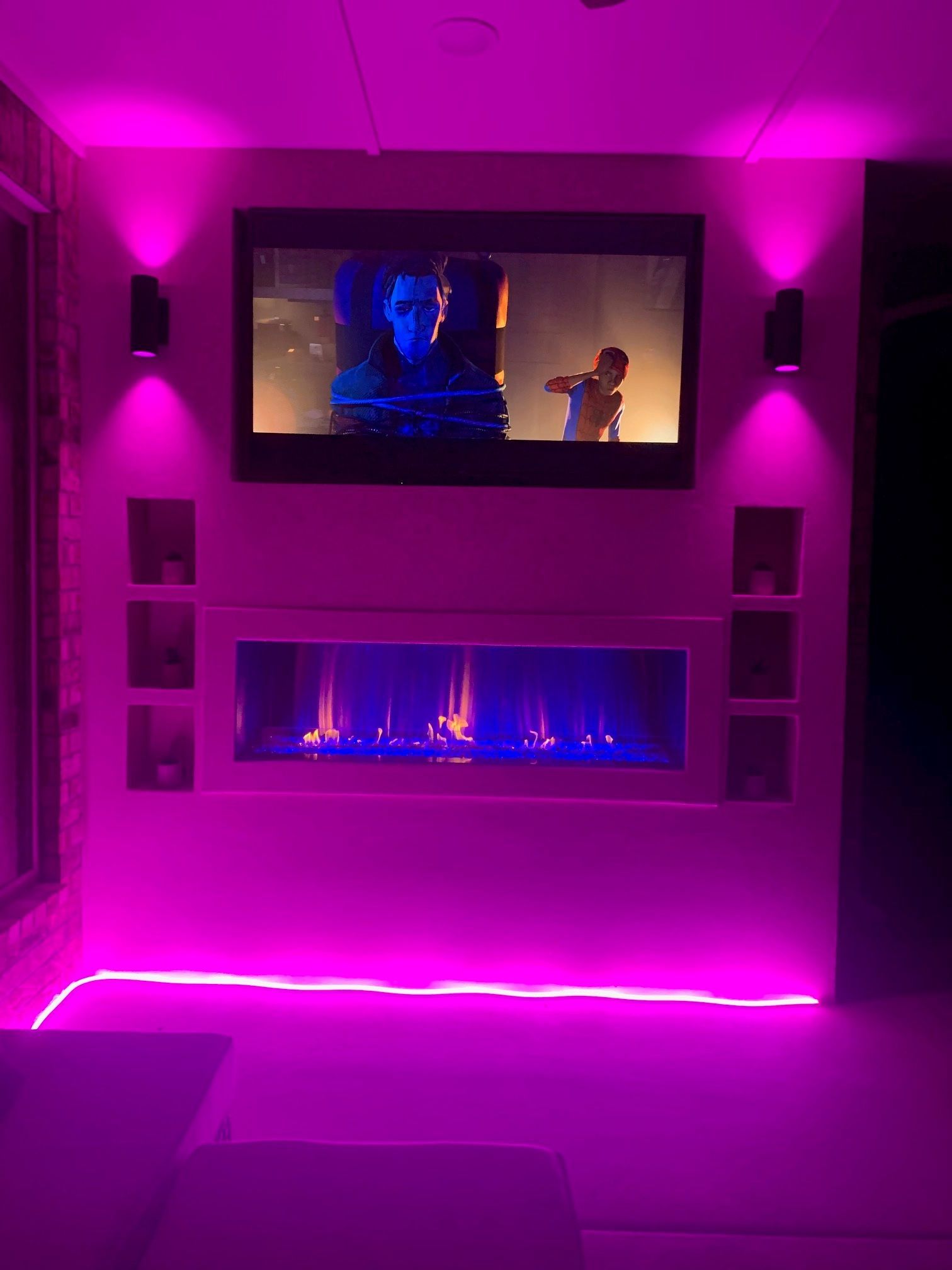 Gas fireplace with faux logs burning with blue and yellow flames, black firebox.