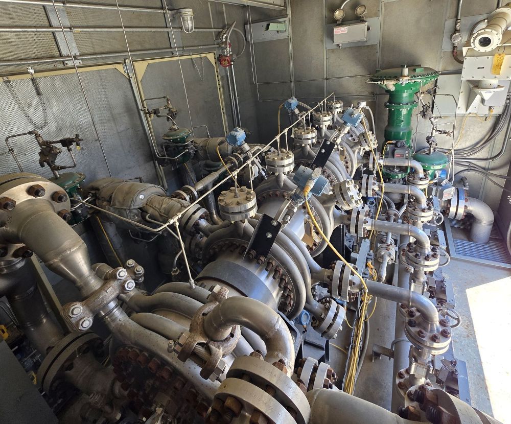 A bunch of metal pipes are connected to each other in a room.