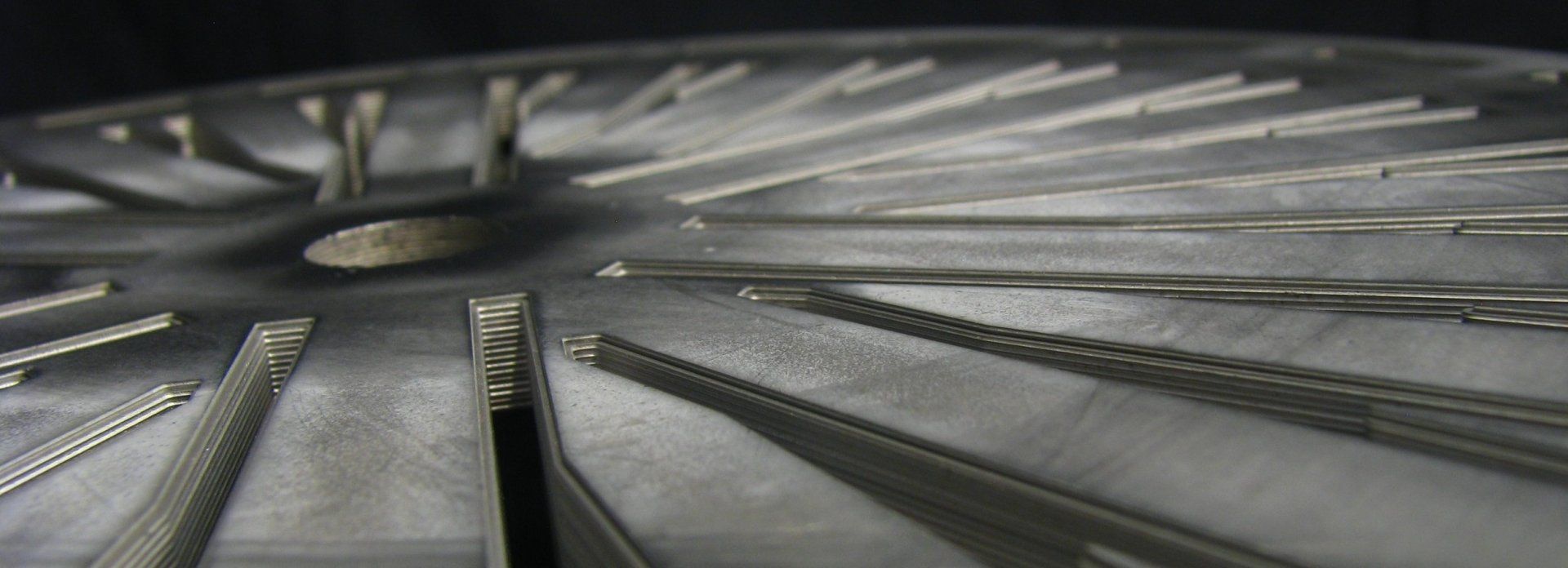 A close up of a metal object with a black background.