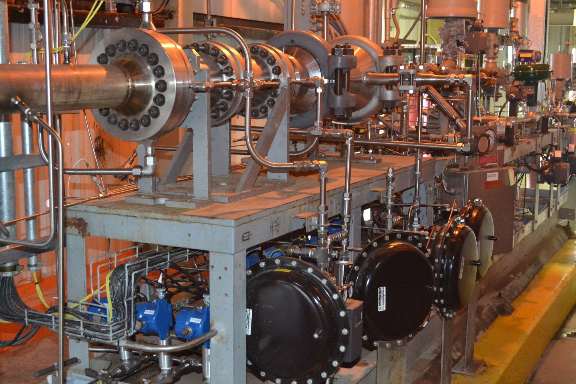 A bunch of pipes are lined up in a factory