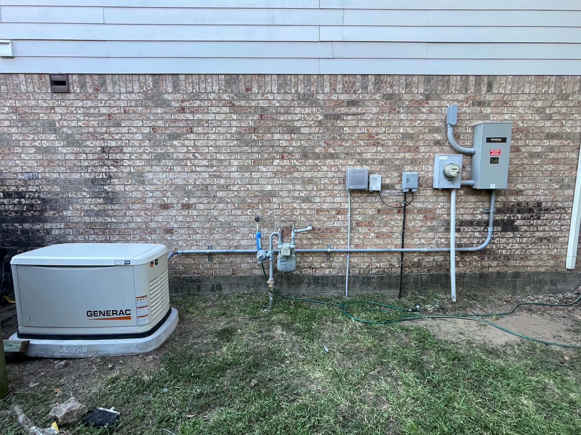 House decorated with Christmas lights at night, featuring green, red, and white lights.