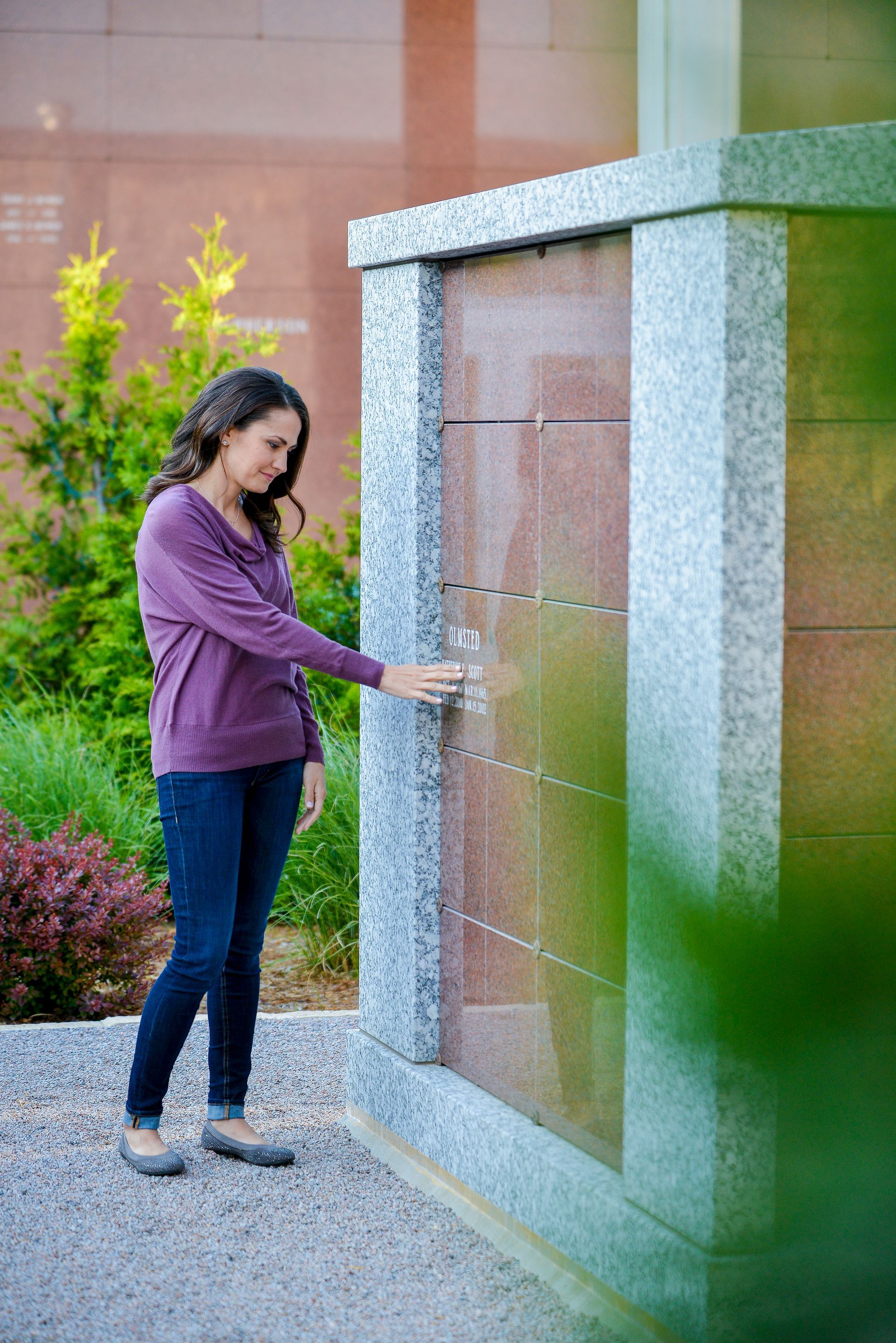 There is a statue of a dove in the middle of a cemetery.