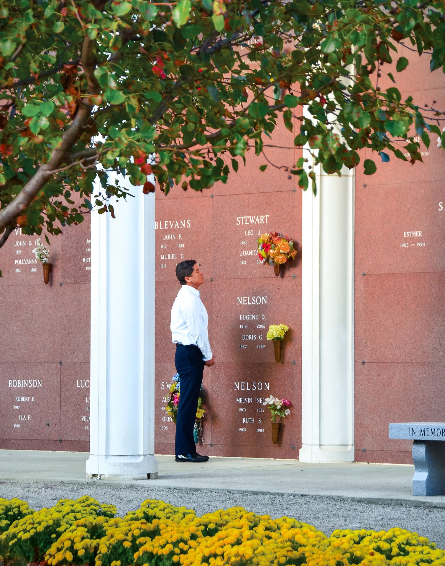 There is a statue of a dove in the middle of a cemetery.