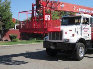 Small Load Crane Service — Red Crane On The Top Of White Truck in Fresno, CA