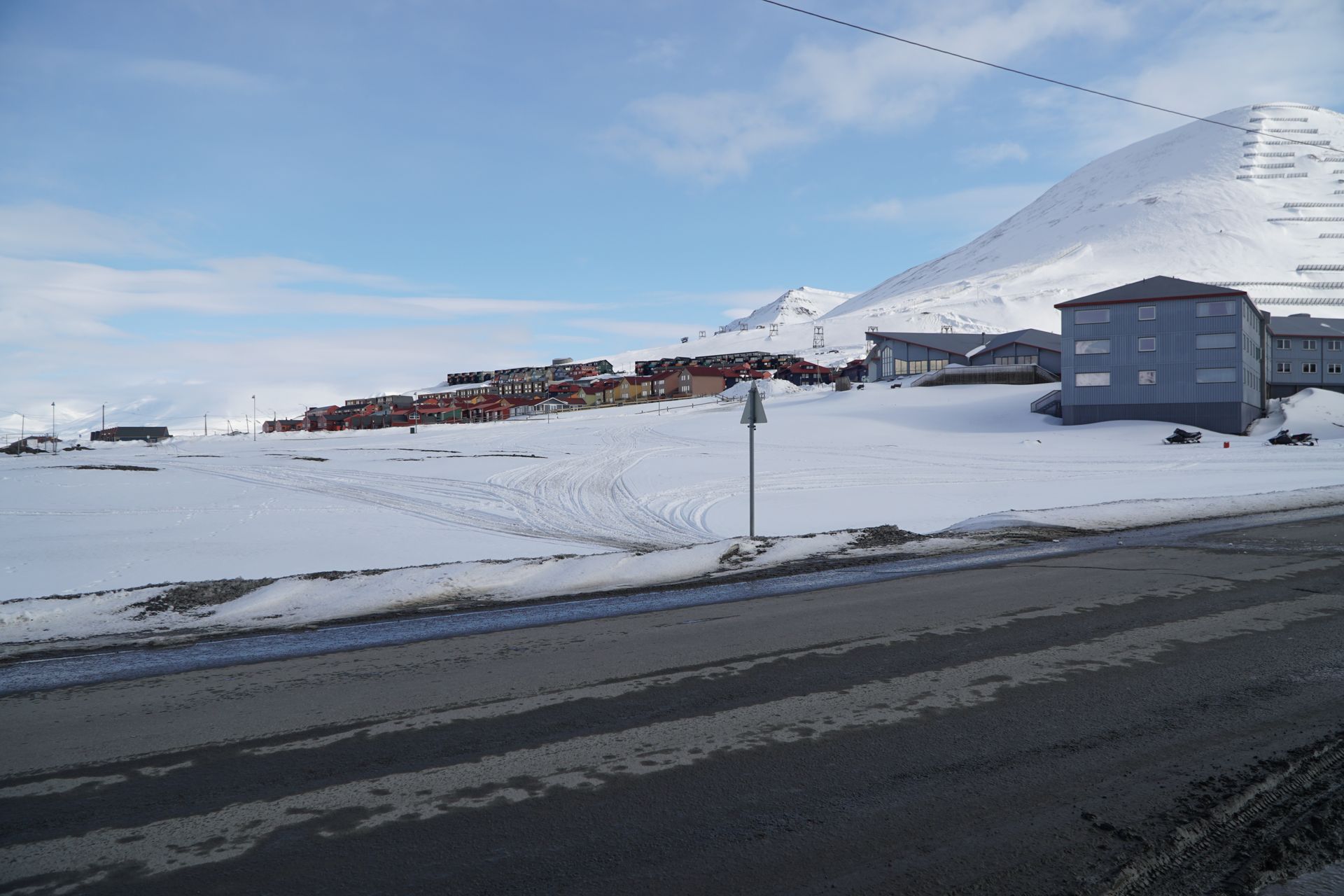 A snowy landscape with a building in the background