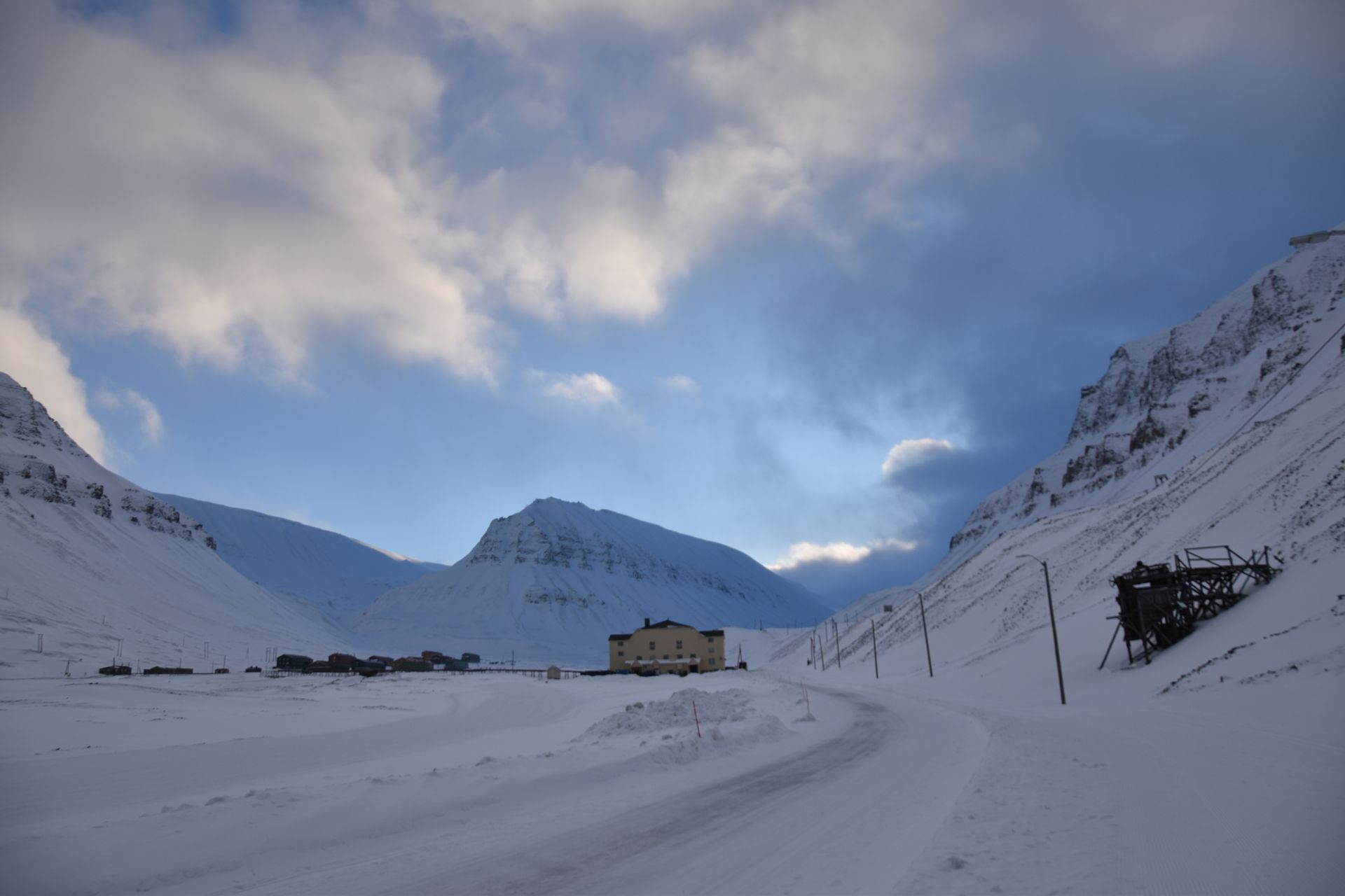 A snowy mountain with a building in the middle of it