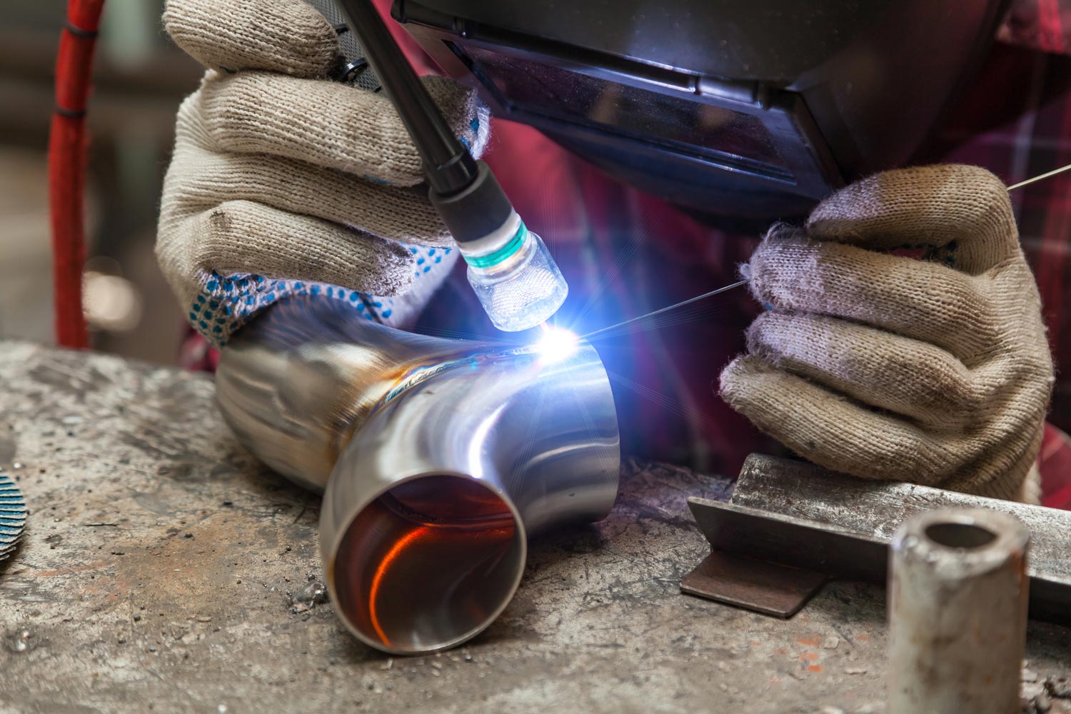 Worker Welding a Steel Pipe — Merrillville, IN — Northwest Indiana Fabrication LLC
