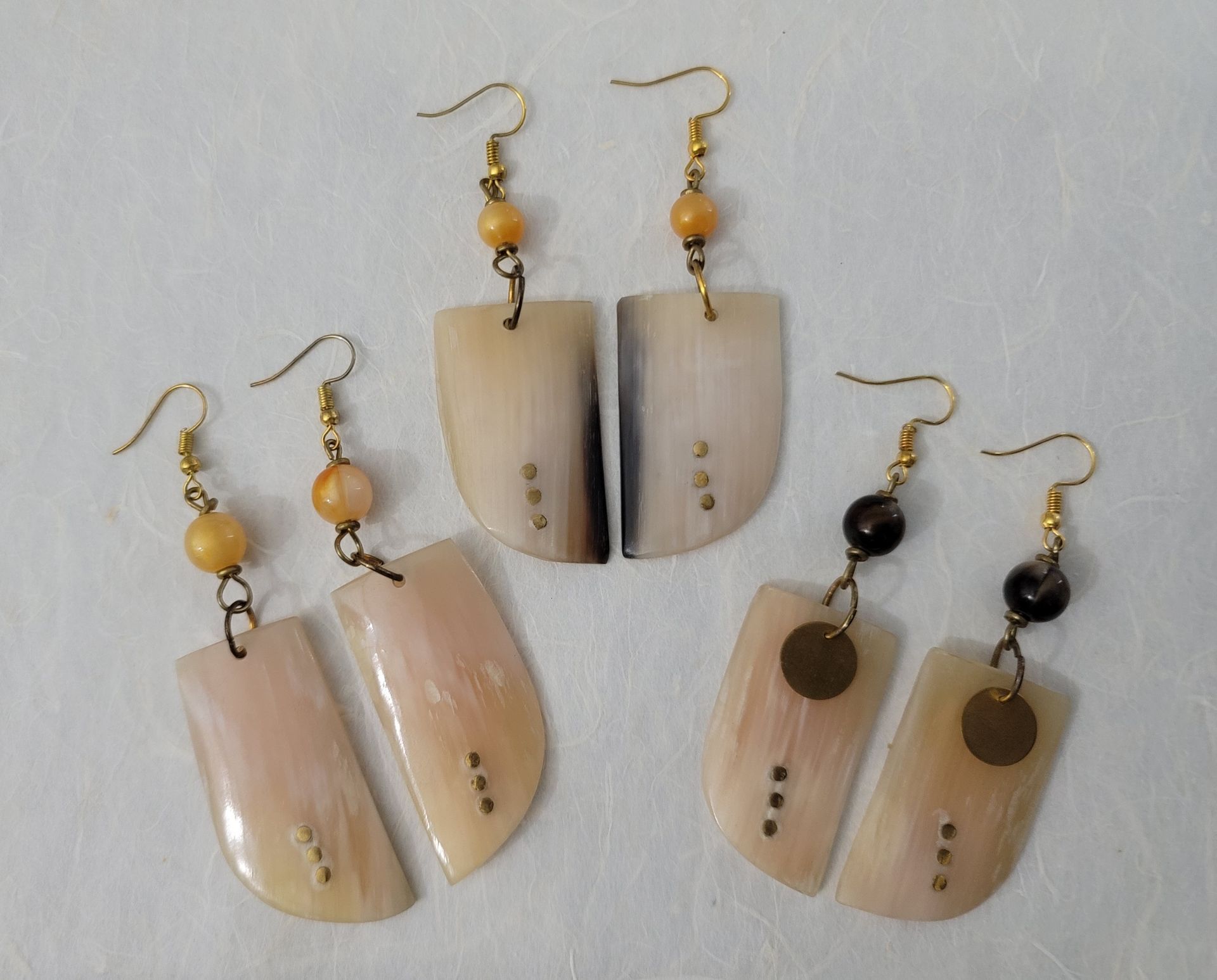 Ankole cow horn earrings, handmade bone earrings, ethical jewelry, African-inspired jewelry, artisan-crafted earrings, sustainable fashion accessories.