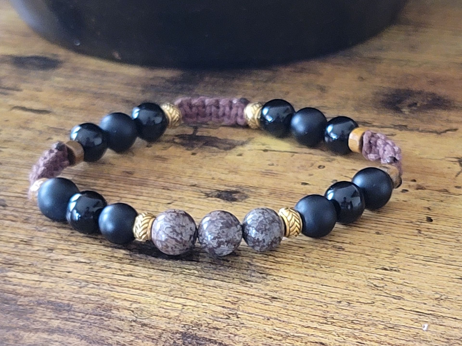 "Handcrafted leather, hematite, and copper necklace inspired by African Diaspora culture"