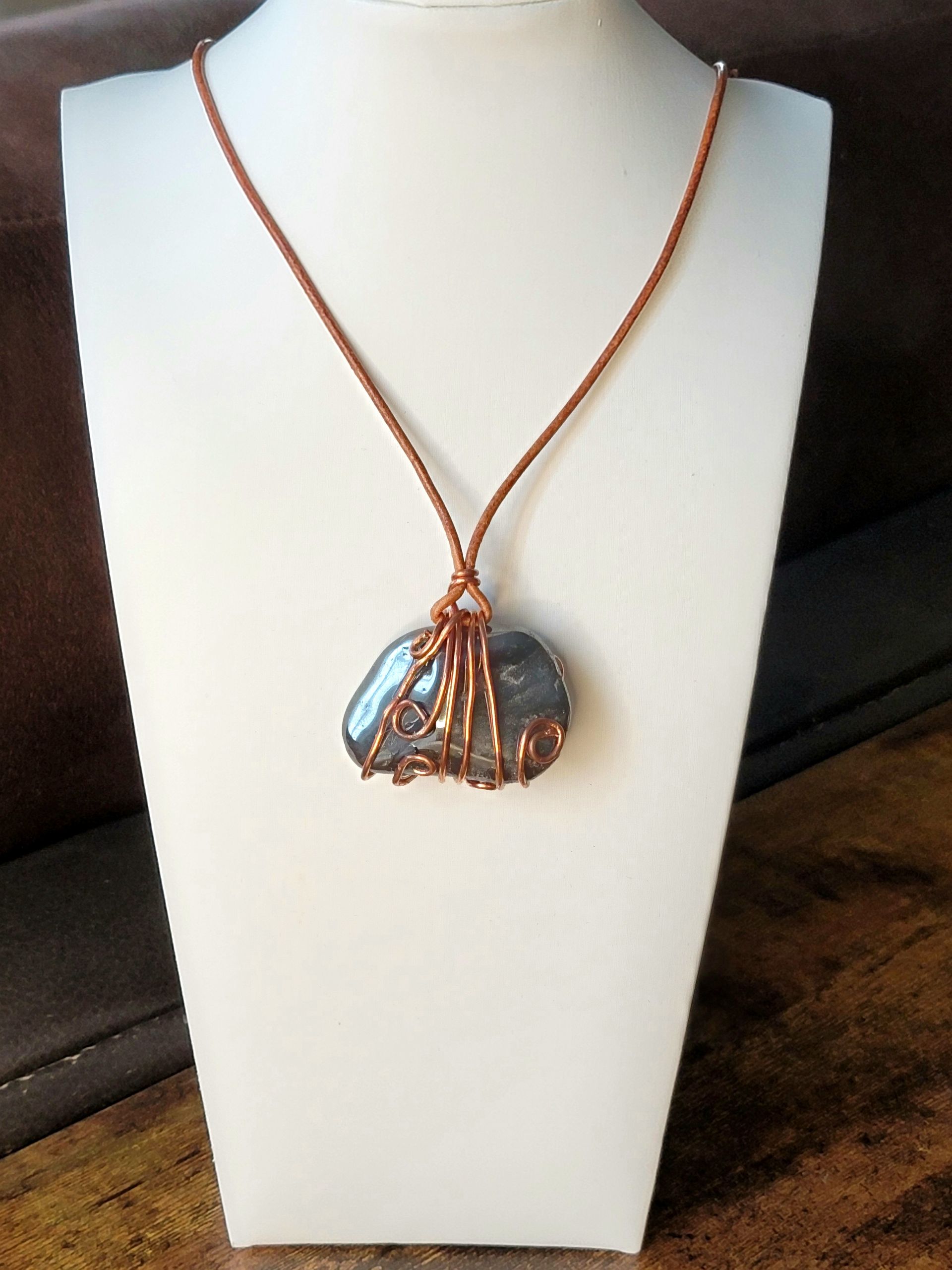 "Handcrafted leather, hematite, and copper necklace inspired by African Diaspora culture"