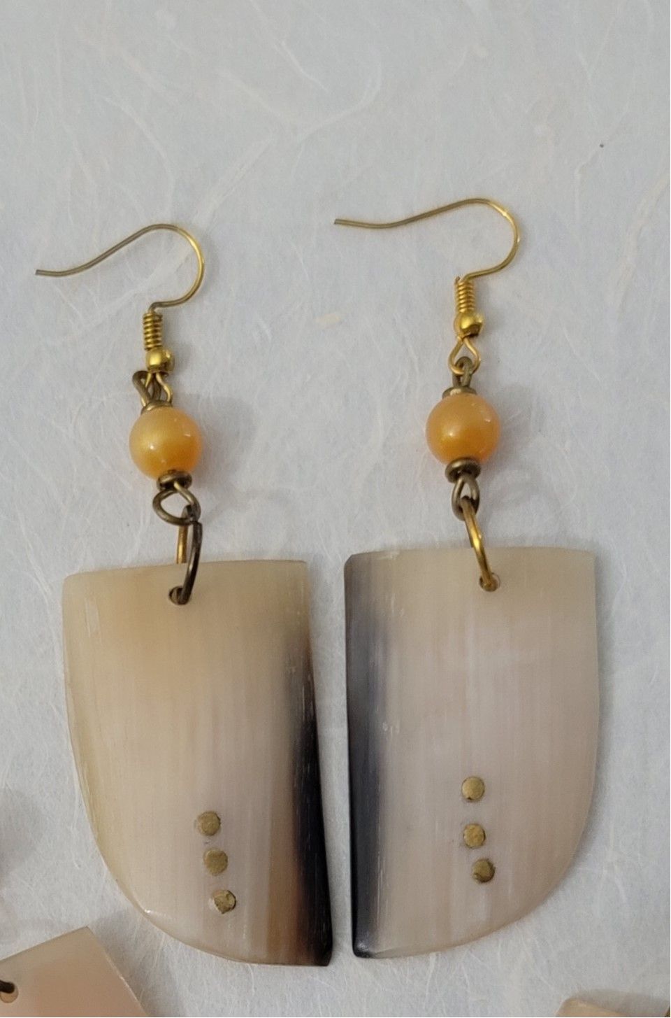 Ankole cow horn earrings, handmade bone earrings, ethical jewelry, African-inspired jewelry, artisan-crafted earrings, sustainable fashion accessories.