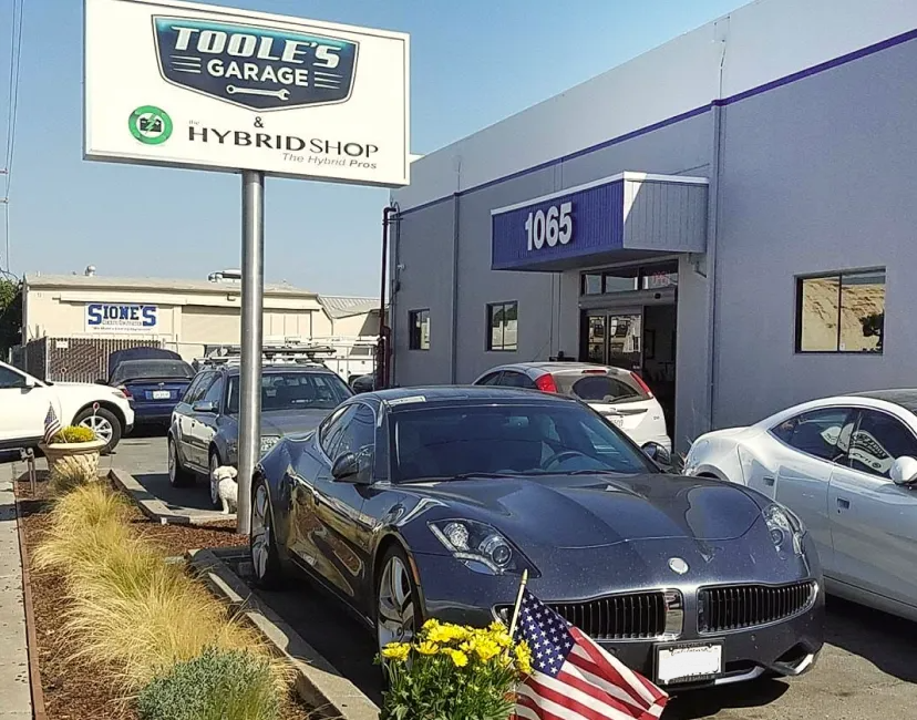 A car is parked in front of a tuddle 's garage