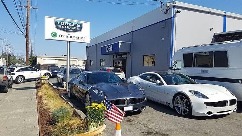 A lot of cars are parked in front of a building.