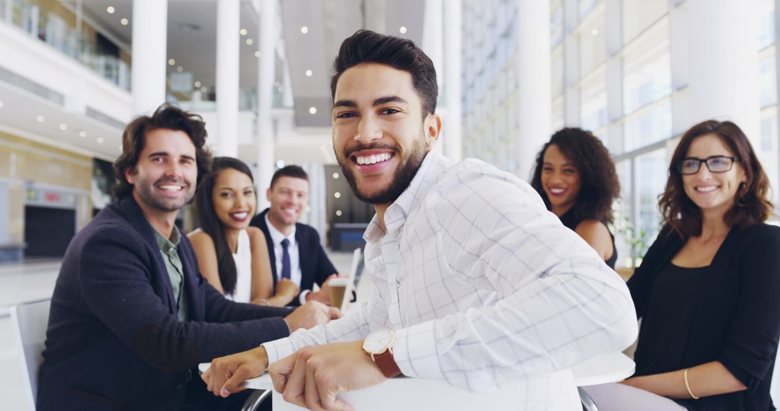 Happy co-workers seated at a table