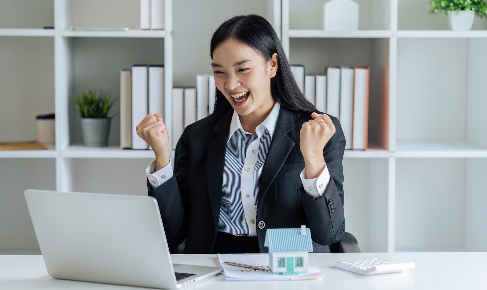 A woman excited by what she's seeing on her computer