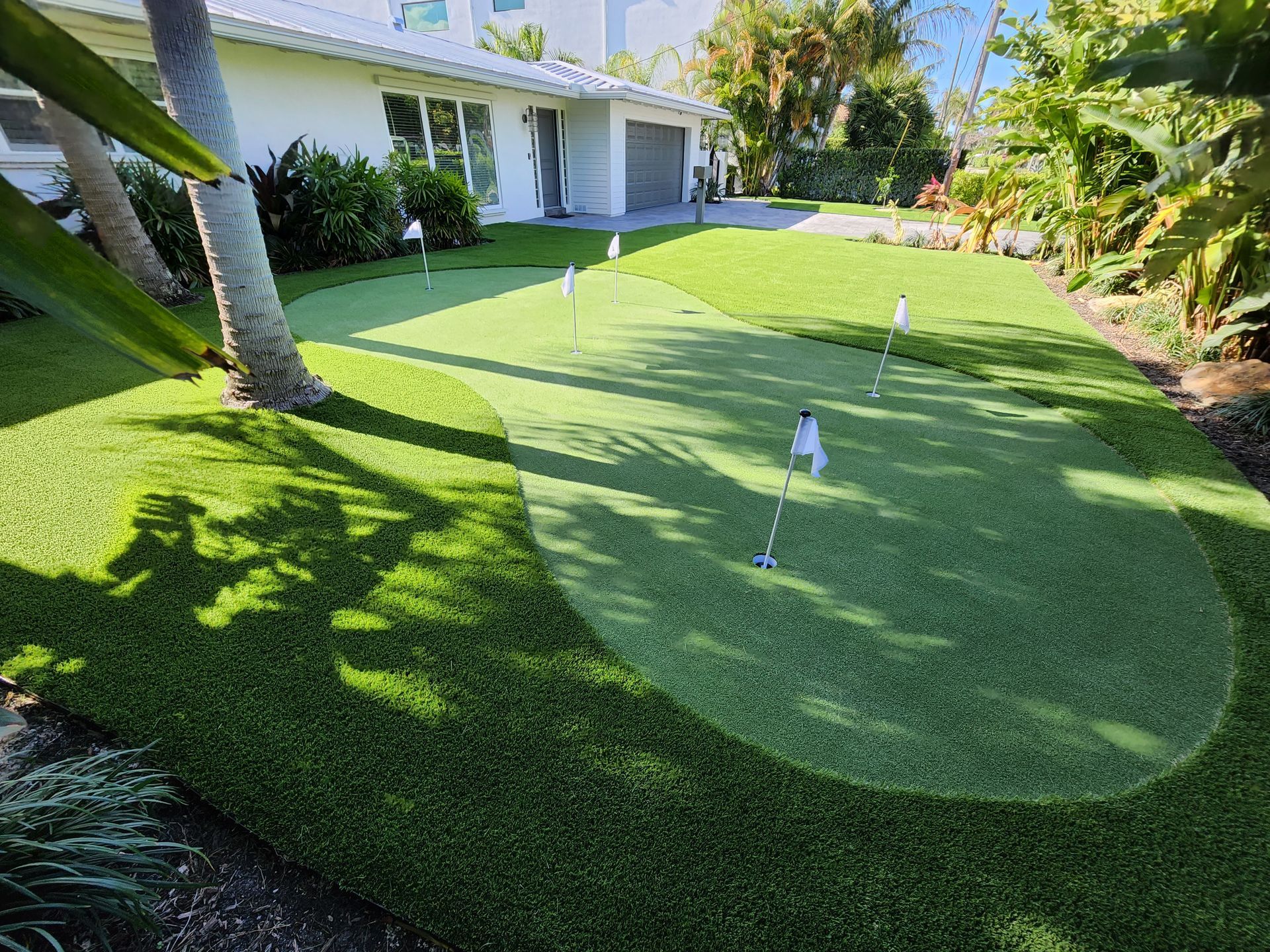 There is a putting green in front of a house.