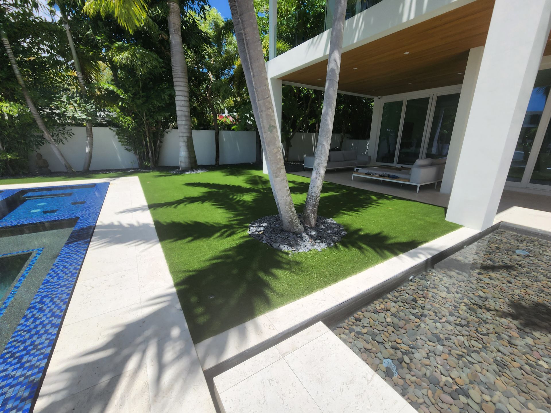 A large white house with a swimming pool in the backyard