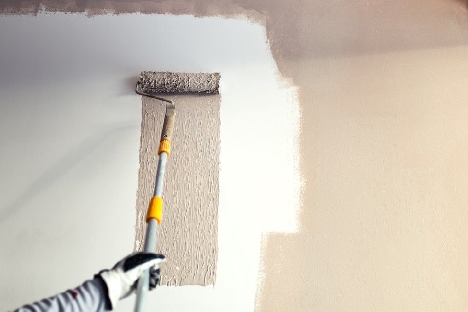 wall being painted using a roller