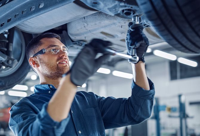 Mechanic at work under car | Brandon's Body Shop & Repair