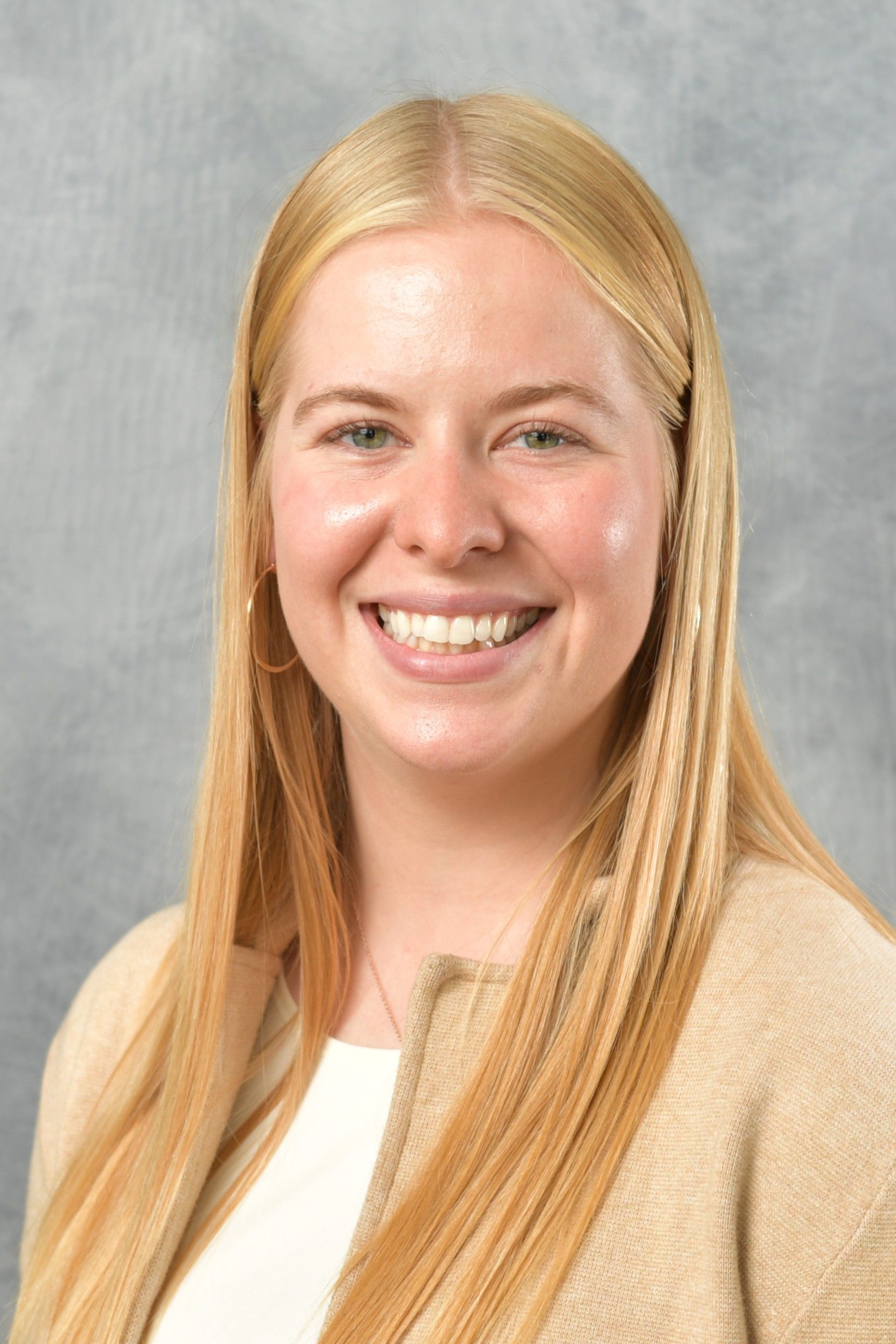 A grayscale depiction of a person wearing a blazer, white shirt, with hair pulled back.