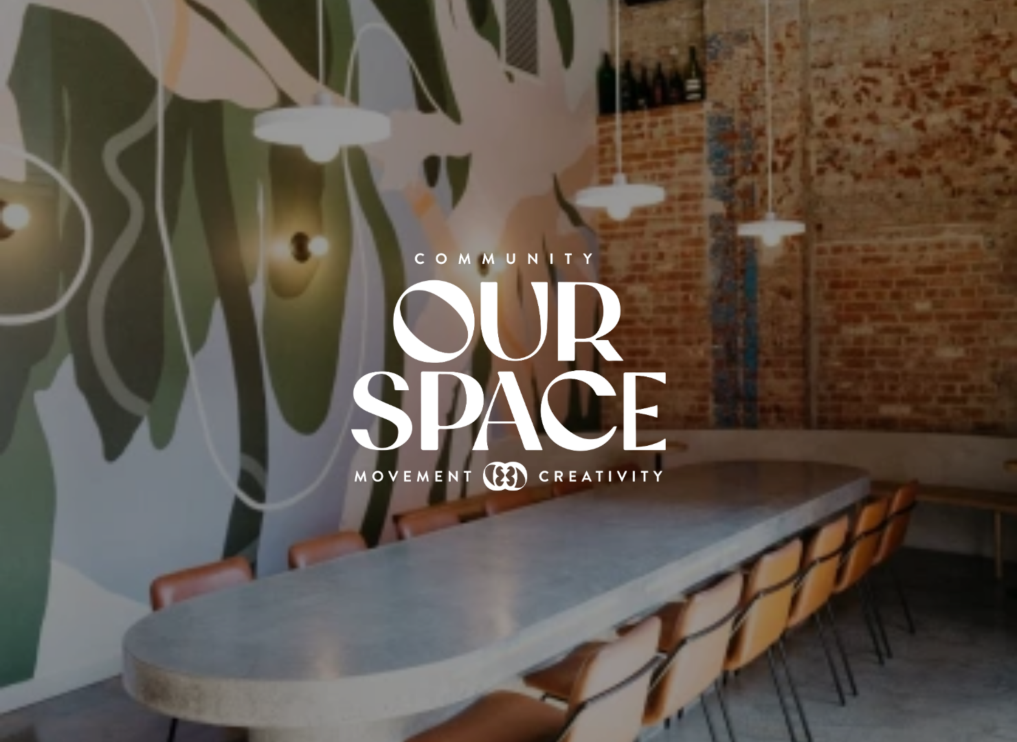 A room with a long table and chairs and the words our space