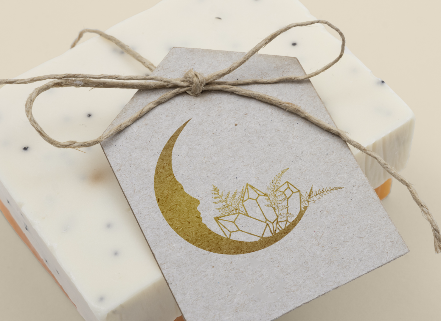 A card with a crescent moon on it is tied to a piece of soap