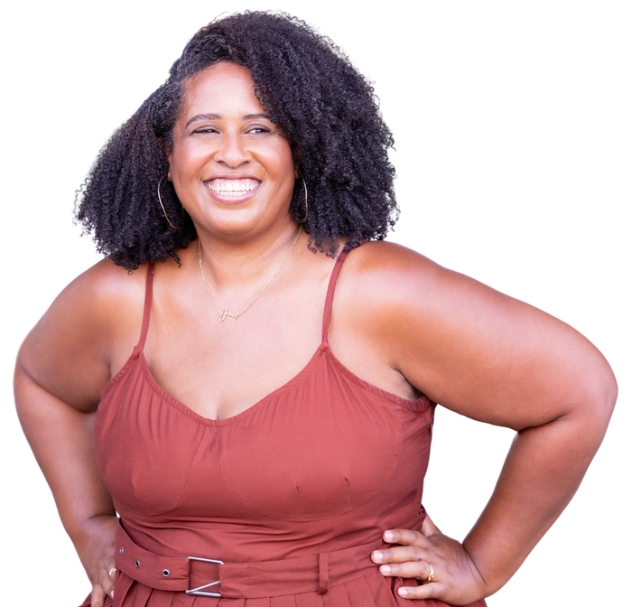 A woman in a red tank top is smiling with her hands on her hips