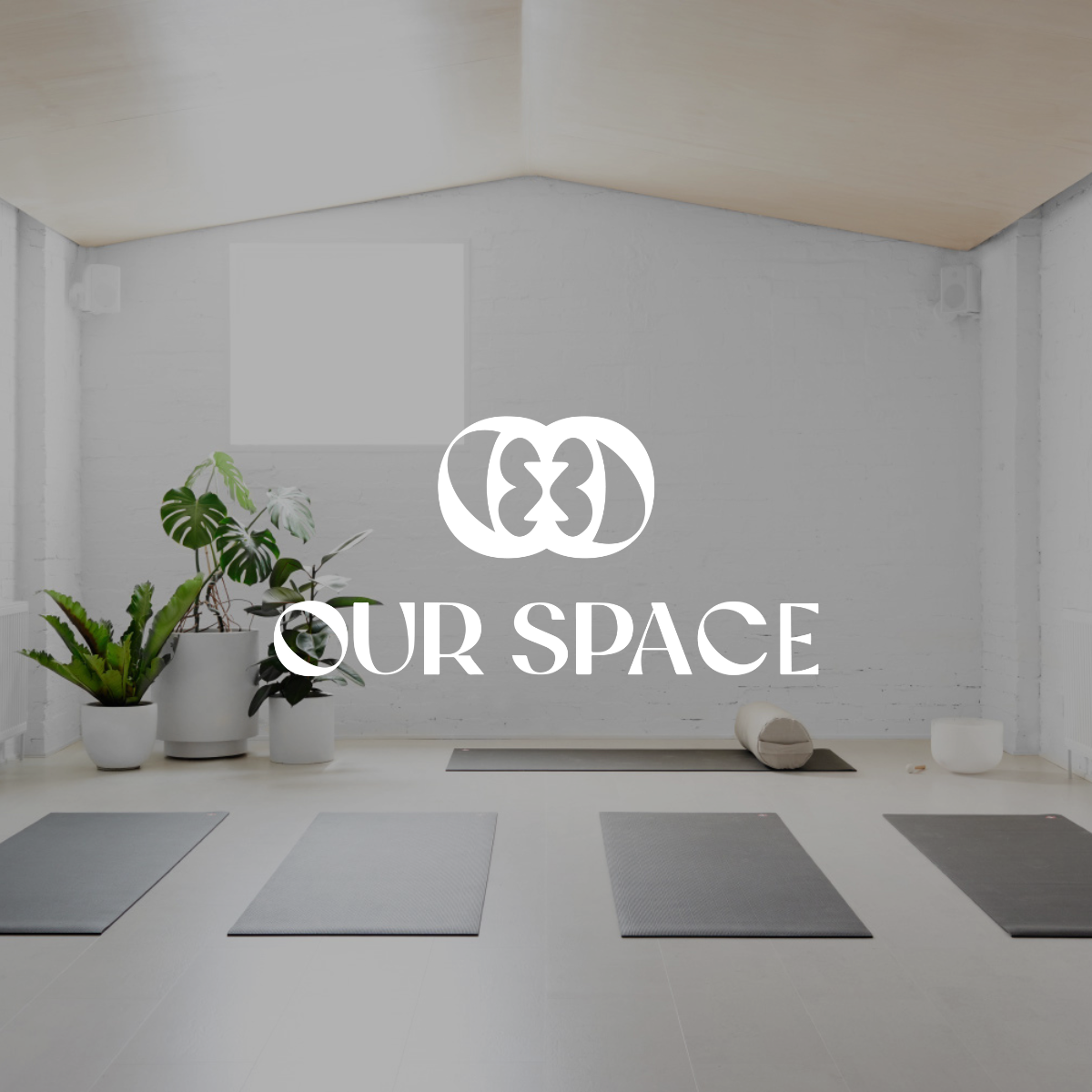 The logo for our space is on the wall of a yoga studio