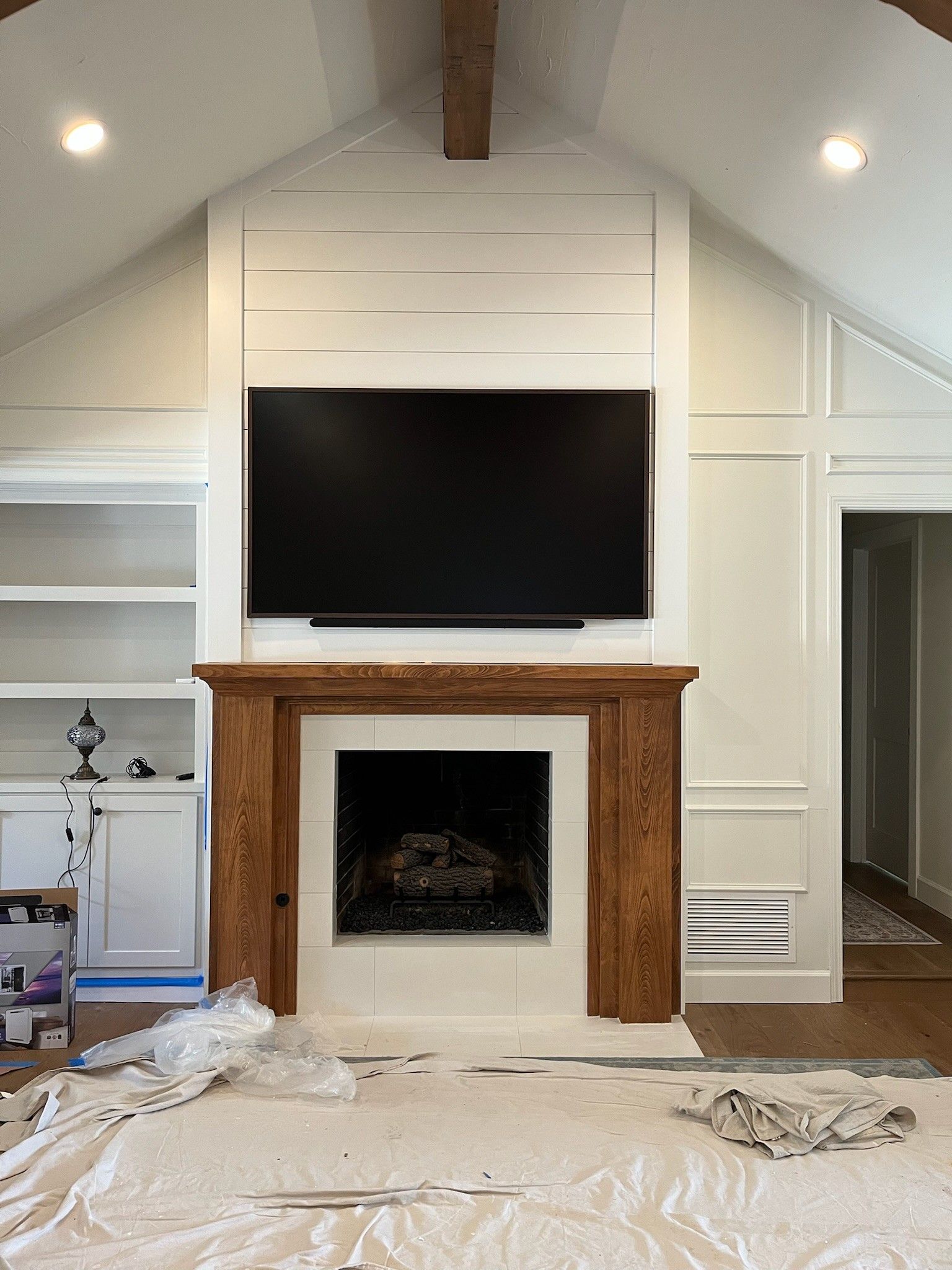 A living room with a fireplace and a flat screen tv above it.