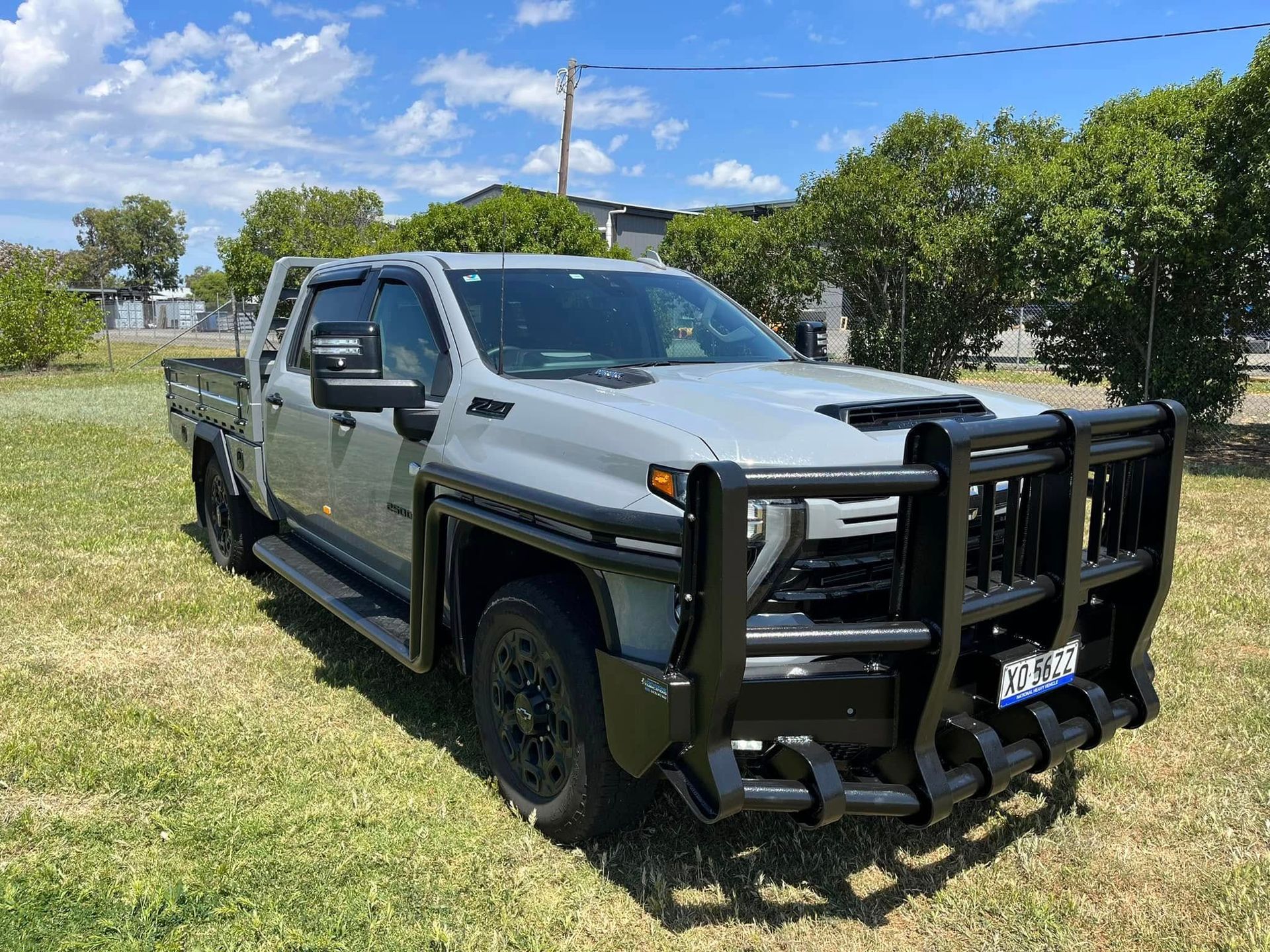 A Silver Truck With a Bumper is Parked in a Grassy Field — Deveigne Fabrications In Brocklehurst, NSW