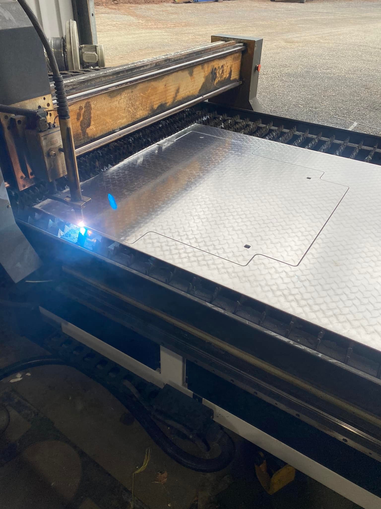 A Blue Trailer is Sitting on Top of a Concrete Floor in a Garage — Deveigne Fabrications In Brocklehurst, NSW