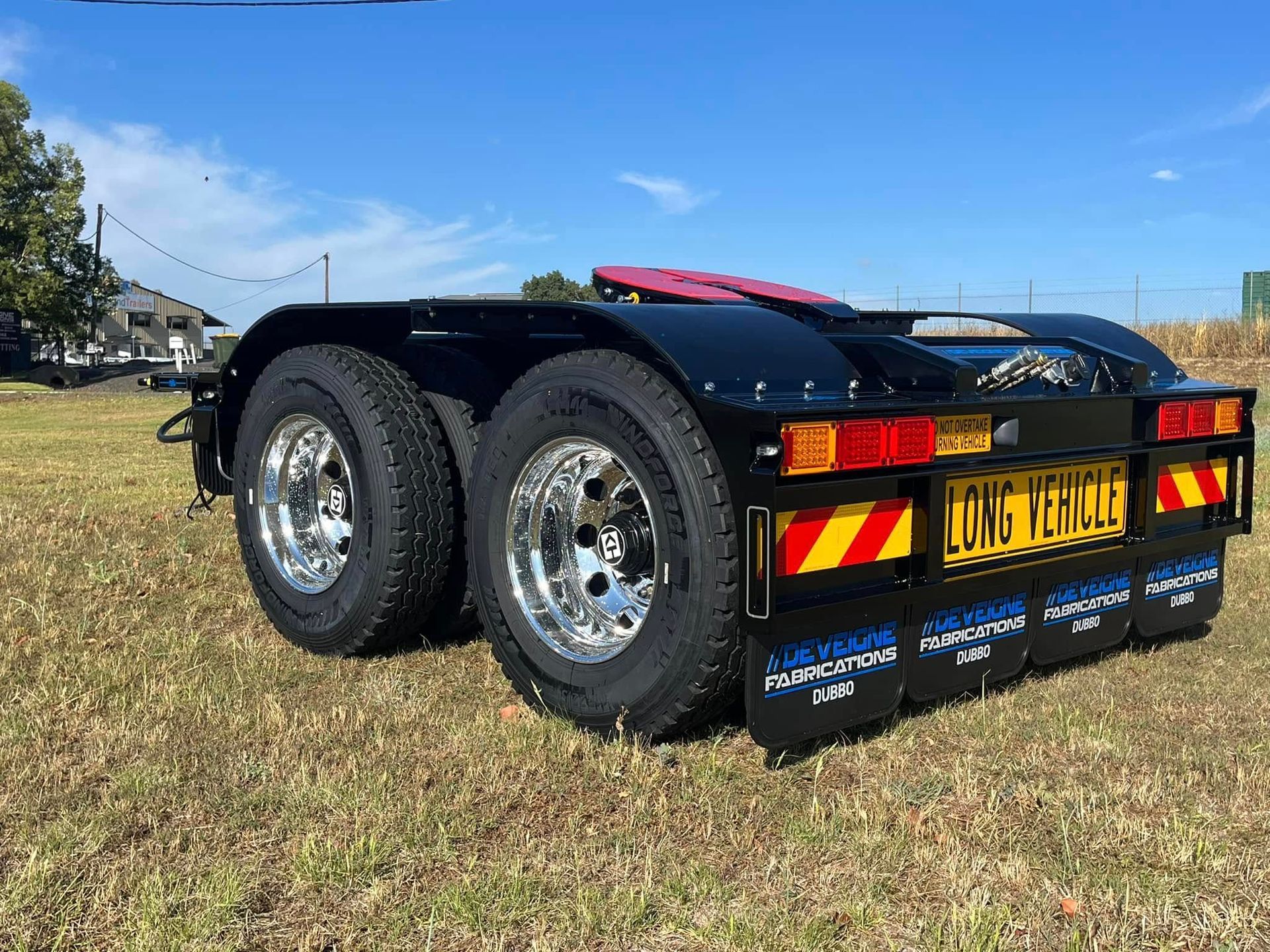 A truck dollie on the grass— Deveigne Fabrications In Brocklehurst, NSW