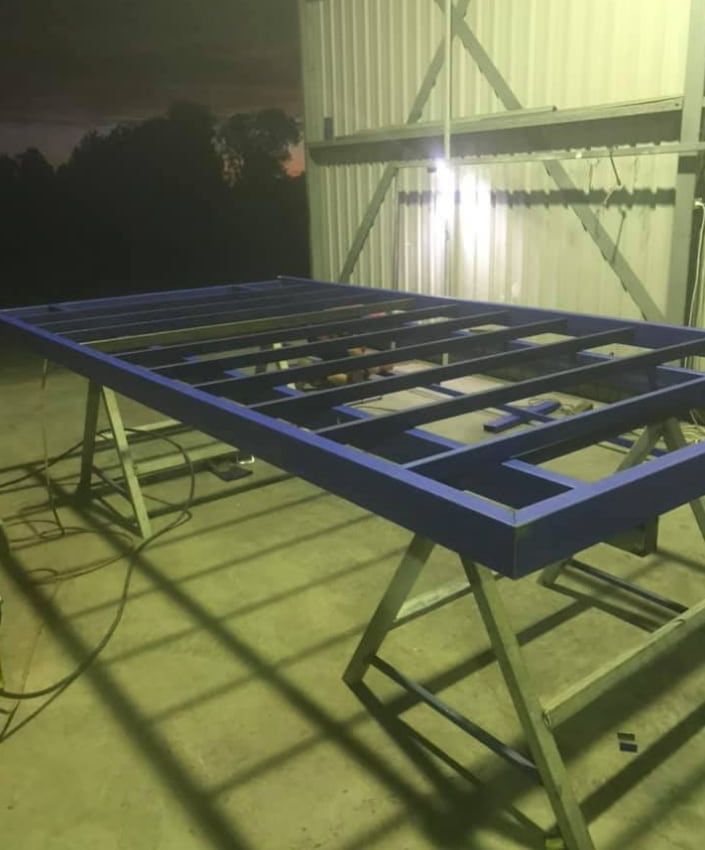 A Blue Metal Frame is Sitting on Top of a Concrete Floor — Deveigne Fabrications In Brocklehurst, NSW