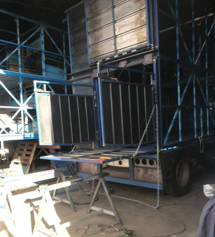 A Blue Truck is Parked in a Garage With a Table in Front of It — Deveigne Fabrications In Brocklehurst, NSW