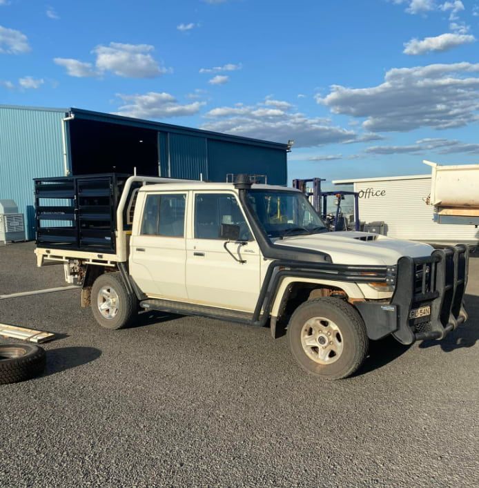 A White Truck With a Tray on the Back is Parked in a Parking Lot — Deveigne Fabrications In Toowoomba, QLD