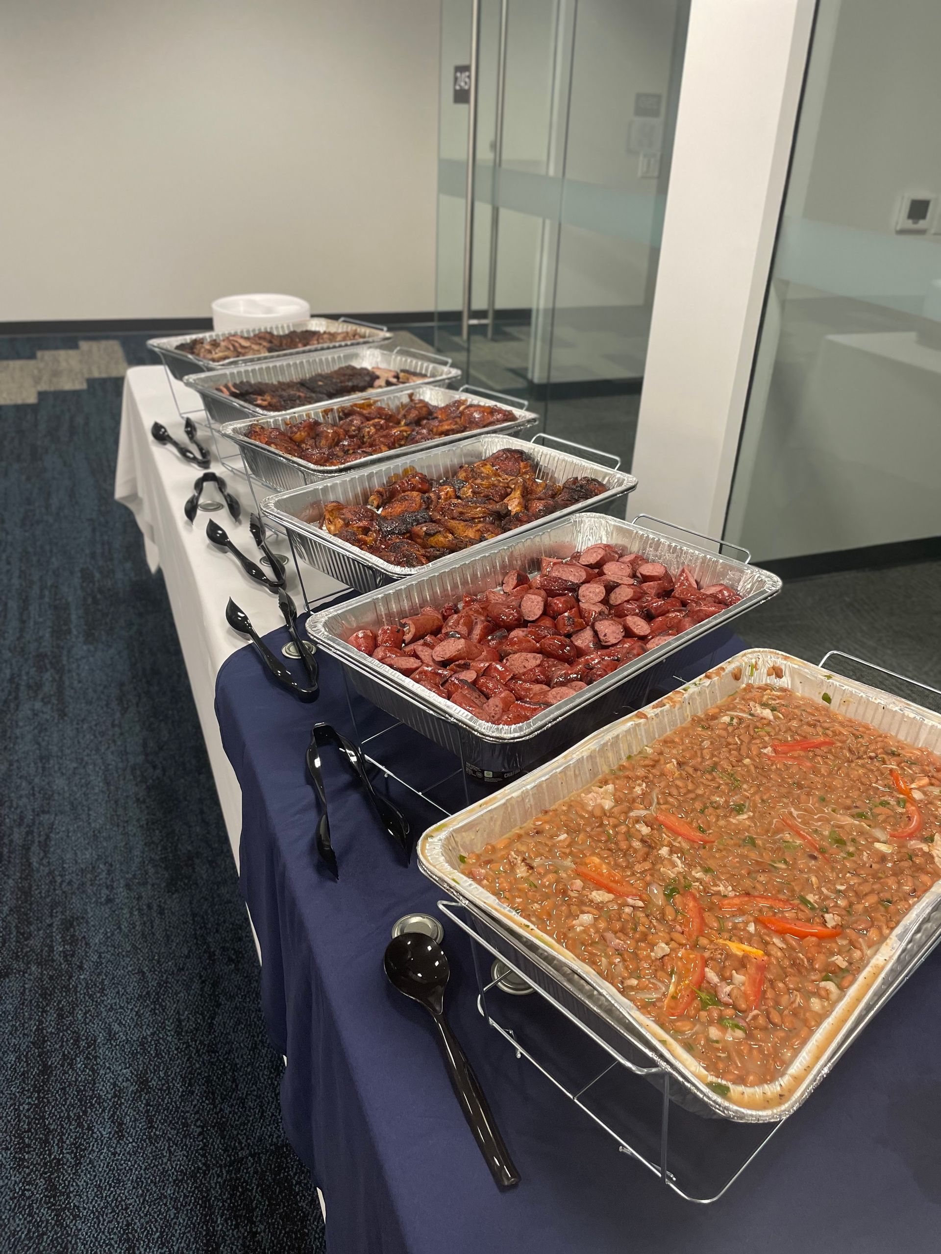 A buffet table with a variety of food on it.