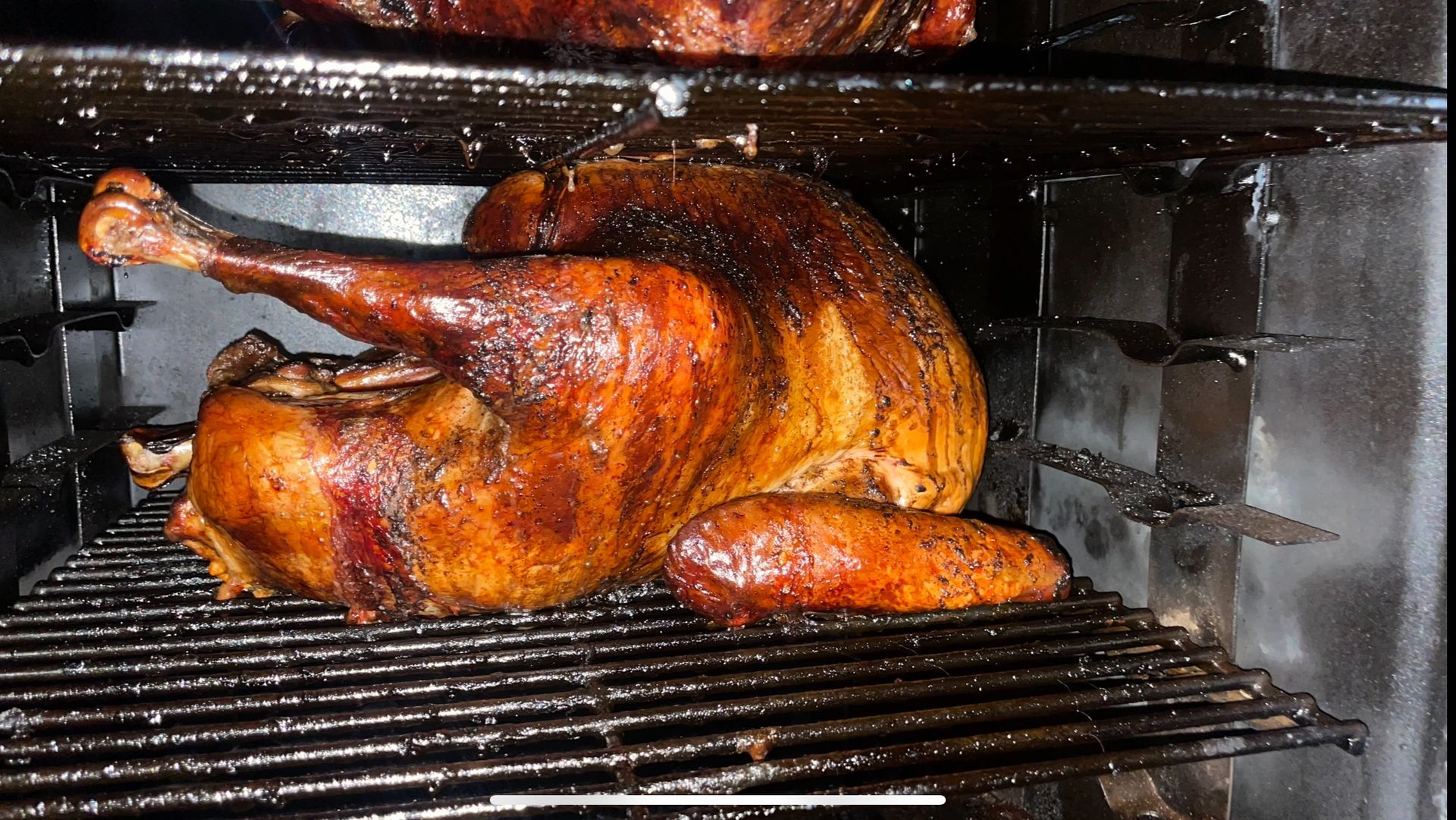 A turkey is being cooked on a grill in an oven