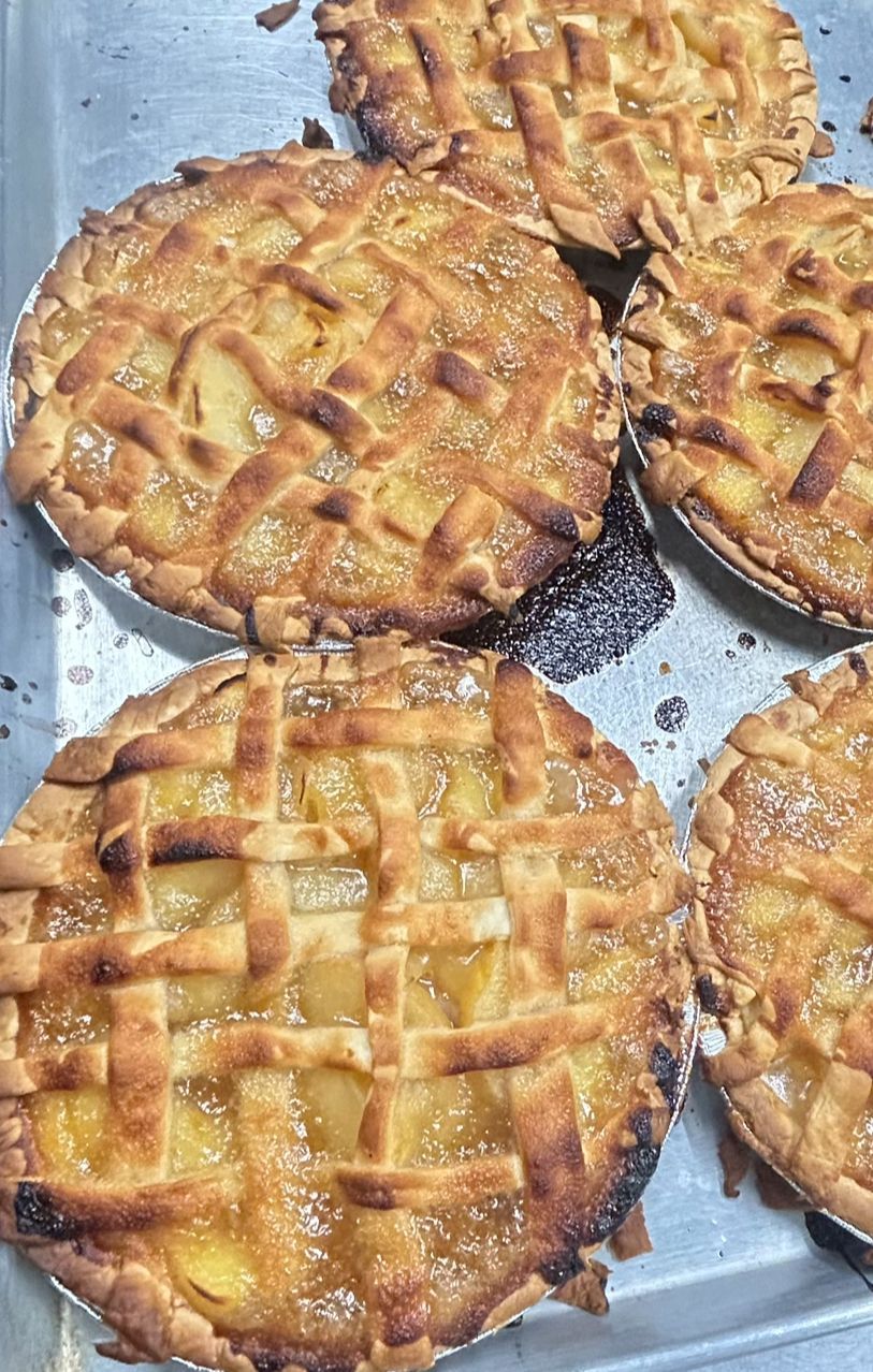 A tray of apple pies with a lattice crust