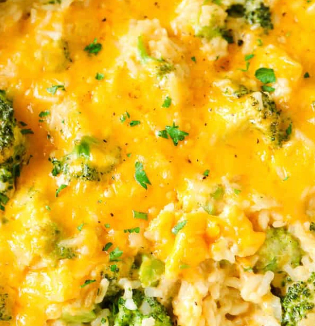 A close up of a casserole dish with broccoli and cheese.